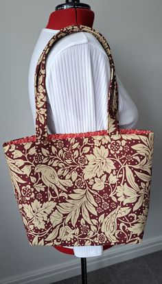 "Tote bag made from light weight cotton canvas with a 100% cotton red vine patterned lining.  Front zip pocket and inside split slip pocket.  Handles are 9.5\" (approx)  from top of bag to top of handle.  The bag measures 15\" wide x 11.5\" deep (approx).  Has a magnetic snap fastener at top." Red Fabric Bag For Everyday Use, Red Fabric Shoulder Bag For Shopping, Red Cotton Canvas Shopping Bag, Red Cotton Canvas Bag For Shopping, Red Rectangular Bag With Canvas Lining, Red Canvas-lined Tote Bag, Red Tote Bag With Canvas Lining, Red Fabric Bag For Daily Use, Red Rectangular Cotton Shoulder Bag