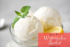 two scoops of lemon ice cream in a glass bowl with mint sprig