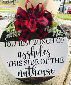 a wooden sign that says jolliest bunch of asbles this side of the nuthouse