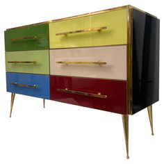 a multicolored chest of drawers with brass handles