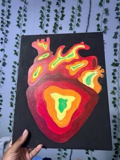 a person holding up a drawing of a heart