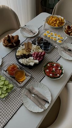 a table topped with plates and bowls filled with different types of food next to each other