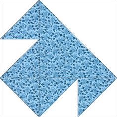 a blue quilt block with an arrow on it