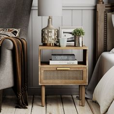 a bedside table with books and magazines on it