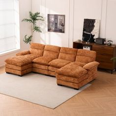 a living room with a sectional couch and rug on the floor in front of it