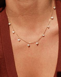 This lightweight and delicate piece features dangle pearl charms that make it perfect for both everyday wear and special occasions. The adjustable length ensures a comfortable fit, while the PVD plated finish ensures that your necklace stays water safe and tarnish resistant. Create a chic and minimal pearl look by layering the Calypso Necklace with your favorite pieces. •Single Necklace• Faux Pearls• 15.5" + 2" extender (to make adjustable) Dainty Adjustable Drop Necklace With Pearl Pendant, Minimalist Pearl Necklace With Delicate Dangle Chain, Minimalist Pearl Necklace With Delicate Chain, Delicate Adjustable Dangle Pearl Necklace, Adjustable Dainty Pearl Necklace, Dainty Adjustable Dangle Pearl Necklace, Dainty Dangle Pearl Necklace With Adjustable Fit, Dainty Adjustable Pearl Charm Necklaces, Adjustable Dainty Pearl Charm Necklaces