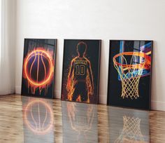 three framed basketball pictures on a wooden floor