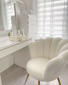 a white chair sitting in front of a mirror