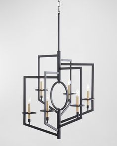 a black chandelier with six candles hanging from the center and four lights on each side