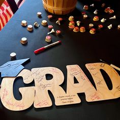 a graduation party table with congratulations letters and confetti