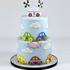 a three tiered cake decorated with cars and numbers on it's top layer