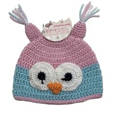 a crocheted hat with an owl face