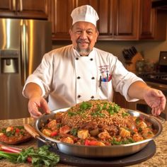 a chef standing in front of a large platter of food