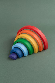 a stack of colorful plastic rings on a green surface