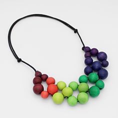 "Looking for a statement necklace that's both eye-catching and comfortable to wear? Look no further than Sylca Designs' adjustable length necklace! Made from lightweight materials and featuring colorful ombre beads, this simple yet striking piece is sure to turn heads wherever you go. Adjustable Length: 18\"-26\"  Beads: .25\"- .5\" D  Care Instructions: Remove jewelry when applying perfumes, creams, washing hands etc. Do not store in direct sunlight. To restore color and shine apply a drop of o Unique Multicolor Wooden Beads Necklaces, Adjustable Bib Necklace With Colorful Round Beads, Multicolor Wooden Beads Necklaces For Jewelry Making, Adjustable Multicolor Bib Necklaces With Colorful Beads, Multicolor Wooden Beads For Jewelry Making, Artisan Rainbow Necklaces With Colorful Beads, Adjustable Artisan Bib Necklace With Round Beads, Rainbow Necklaces With Large Round Beads, Rainbow Necklace With Large Beads