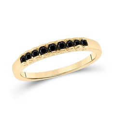 a yellow gold ring with black stones