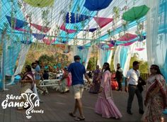 several people are walking under colorful umbrellas