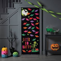 a halloween door decoration with bats and pumpkins