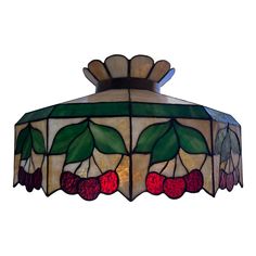 a stained glass light fixture with cherries on it