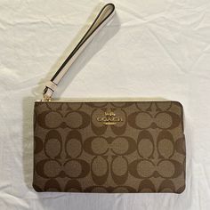 Nwt Classic Coach Wristlet Elegant Brown Wristlet For Everyday Use, Coach Beige Clutch Wristlet, Beige Travel Wristlet With Wrist Strap, Beige Wristlet With Wrist Strap For Travel, Elegant Brown Wristlet For Daily Use, Brown Wristlet With Removable Pouch, Elegant Brown Wristlet With Removable Pouch, Elegant Brown Wristlet With Zipper Pouch, Elegant Brown Pouch Wristlet