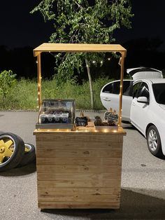 a car parked next to a wooden box with lights on it