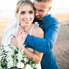 a bride and groom embracing each other on their wedding day