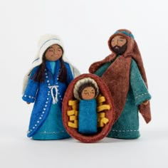 two nativity figurines, one in blue and the other in brown