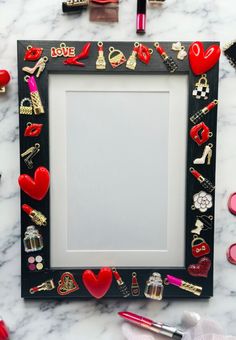 a black frame filled with lots of different types of jewelry on top of a marble counter