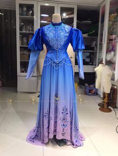 a blue and purple dress on display in a store