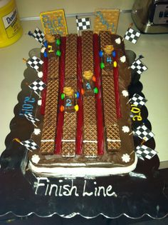 a cake that is shaped to look like a race track with the number thirteen on it