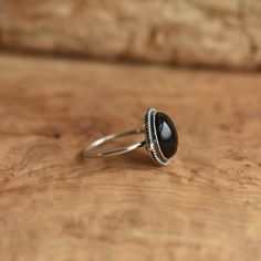 This is a perfect dainty black ring - .925 Sterling Silver - Black Onyx Sometimes you want to gaze down at your ring and see perfect balance and grace. That's what the Delica Dainty Ring has to offer. High- grade Black Onyx with a simple, sterling silver design. Perfect little ring. Lovely, traditional, dainty ring of 10 x 12mm Black Onyx cabochon set in .925 sterling silver oxidized and burnished bezel and wire. Simple, elegant and perfect. This lovely little ring is created using traditional s Silversmith Rings, Chloe Ring, Black Onyx Jewelry, Lapis Ring, Purple Rings, Purple Amethyst Ring, Onyx Jewelry, Gold And Silver Rings, Zierlicher Ring