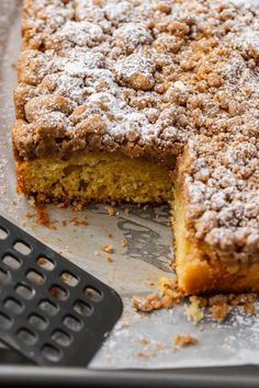 a close up of a cake on a pan with one slice cut out and the other half eaten