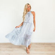 Featuring an elegant halter neckline with button closure detail, stripe pattern throughout, and a tiered skirt with lining beneath. Pair this dress with your favorite heels and light cardigan for your next outing. Sizes: Small 0-4 (Length approx. 51") Medium 6-8 (Length approx. 51.5") Large 10-12 (Length approx. 52") X Large 14-16 (Length approx. 52.5") Product Fit & Details Model Info: Model is 5'6'' wearing size Small. Fit of Product: Relaxed Fit Material: 100 % Polyester Sizing: Runs true Chic Striped Tiered Dress, Striped Tiered Skirt Summer Dress, Striped Tiered Summer Dress, Spring Striped Halter Dress, Light Cardigan, Halter Maxi Dress, Halter Maxi, Halter Maxi Dresses, Halter Neckline