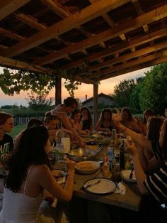 a group of people sitting around a table eating food