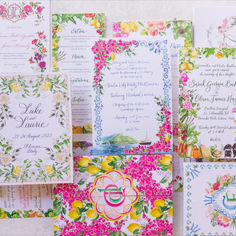 the wedding stationery is decorated with flowers and fruit