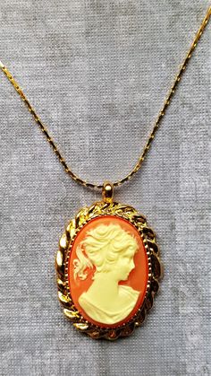 Lovely Vintage Cameo framed in golda keepsake for any age.   Vintage is so Modern! Aurora Whispers Collection Cameo Costume Jewelry Necklace As Gift, Cameo Costume Jewelry Necklace For Gift, Gold Cameo Medallion Jewelry, Gold Medallion Cameo Jewelry, Gold Cameo Locket Necklace Collectible, Elegant Gold Cameo Locket Necklace, Cameo Yellow Gold Necklace Gift, Gold Cameo Jewelry Gift, Gold Cameo Jewelry As Gift