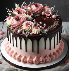 a chocolate cake with pink and white flowers on top