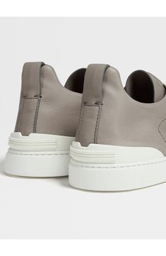 The Secondskin Triple Stitch sneaker features a glove-leather upper for mold-to-your-foot comfort and is mounted on an extralight rubber sole for a sleek look. The brand’s signature crossover elastic straps ensure an easy slip-on fit. Pull-on style with elastic laces Leather upper and lining/synthetic sole Made in Italy Designer Shoes Leather Slip-on Sneakers With Vibram Sole And Round Toe, Functional Leather Custom Sneakers, Functional Leather Custom Sneakers With Vibram Sole, Functional Leather Custom Sneakers With Contrast Sole, Modern Leather Slip-on Sneakers With Vibram Sole, Leather Slip-on Sneakers With Vibram Sole For Sports, Functional Leather Low-top Slip-on Sneakers, Functional Low-top Leather Slip-on Sneakers, Functional Leather Custom Sneakers For Light Sports