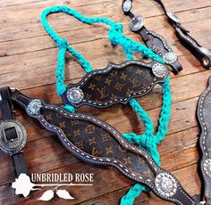 a cowgirl's belt with turquoise braiding and silver buckles on it