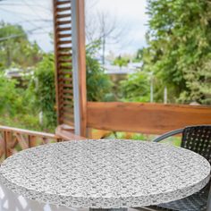 an outdoor table and chairs on a patio with trees in the backgrouf