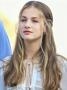 a girl with long hair wearing a white shirt