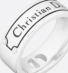 The silver ring has a modern and streamlined silhouette that showcases the engraved Christian Dior Couture signature. The ring can be paired with the matching necklace and bracelet.. S Designer Sterling Silver Jewelry With Polished Finish, Designer White Gold Sterling Silver Jewelry, Designer Silver Jewelry With Polished Finish, Designer White Gold Ring In Sterling Silver, Designer Engraved Sterling Silver Jewelry, Designer Sterling Silver Ring, Designer Adjustable Sterling Silver Jewelry, Designer Adjustable Jewelry With Polished Finish, Designer Jewelry With Polished Finish And Adjustable Fit