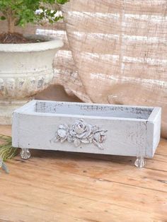 a white planter sitting on top of a wooden table