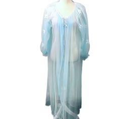 Vintage Miss Elaine Light Blue 60's Sheer Chiffon Robe  Stunning light blue with floral design on the arms  Tie front with 2 buttons  Good overall vintage condition but has 1/2'" hole on bottom and small hole near that (both in right front near hem as seen in last pic)  Not sure if size but it should fit most regular sizes  Length is approximately 50" *Please note that the date selected in the "when was it made" section on Etsy for each listing is based on my best guess. I'm a reseller and I can't always determine the age of a garment. I do my best to list the approximate age. If you have a concern about the garment age and this would cause you hesitation about buying, I kindly ask that you not purchase.  Please see all photos and ask any questions prior to purchase. If for any reason you Light Blue Long Sleeve Nightgown For Spring, Sheer Long Sleeve Summer Nightgown, Sheer Blue Sleepwear For Spring, Light Blue Sleepwear For Wedding Night In Spring, Vintage Blue Sheer Sleepwear, Blue Sheer Vintage Sleepwear, Blue Sheer Sleep Dresses, Sheer Blue Sleep Dresses, Sheer Blue Nightgown For Bedtime