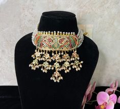 Beautiful jadau Polki Choker layered with pearls this is intricate art done with expert craftsmen .  Tika and Rings can be matched ton complete the look. light weight and Premium Quality.  Two styles shown one with long Rani Haar and another with just necklace. suitable if girl wants traditional look or brides mom for herself.  All Jewellery gets checked then dispatched. Immediate Dispatch available. No Exchange No Refunds. Comes in secured Box. Color shade displayed can vary slightly due to digital image limitations and Lighting.I hope its understood. Please expect these slight variations and imperfections when buying handmade jewelry. Jewellery Care:- Keep all Cubic Zirconia,American Diamond jewellery in a Ziplock Bag to protect it from Moisture and will last the Polish. Keep all Jewelle Ceremonial Kundan Necklace With Latkans For Eid, Ceremonial Kundan Necklace For Eid With Latkans, Temple Jewelry Bridal Necklace With Latkans For Eid, Traditional Bridal Necklace With Latkans For Eid, Bollywood Style Kundan Necklace With Latkans For Ceremonial Occasions, Traditional Kundan Necklace For Eid Ceremonial, Heavy Kundan Necklace For Ceremonial Occasions During Eid, Festive Multicolor Bridal Necklace With Zari Work, Traditional Jhumkas For Eid Ceremonial