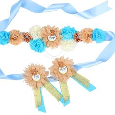 two blue and white flowers with ribbons around them on a white background, one has a name tag attached to it