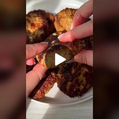 a person is grabbing some food from a plate with other foods on it and the video appears to be blurry