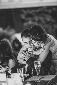 black and white photograph of two people hugging each other