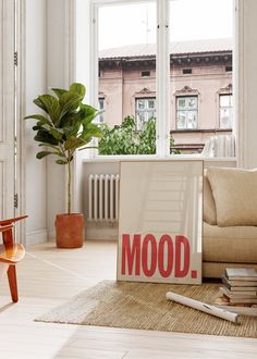 a living room filled with furniture and a sign that reads'mood'on the floor