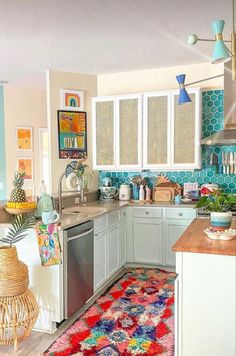 a kitchen with an area rug on the floor